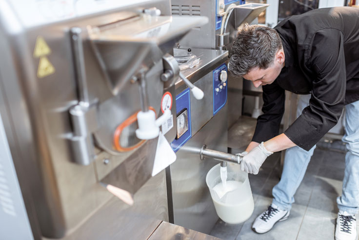 chef-pouring-pasteurized-milk-from-the-pasteurizer-2025-03-17-23-04-01-utc
